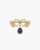 Close-up of a vintage gold crown-style S925 silver ring with a dangling teardrop natural lapis lazuli stone.