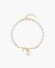 Macro view of a gold-plated S925 silver bracelet featuring organic entwined vines and several natural white freshwater pearls on a white background.