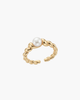 Close-up of a gold-plated twisted croissant-style S925 silver ring with a central natural pearl on a white display stand.