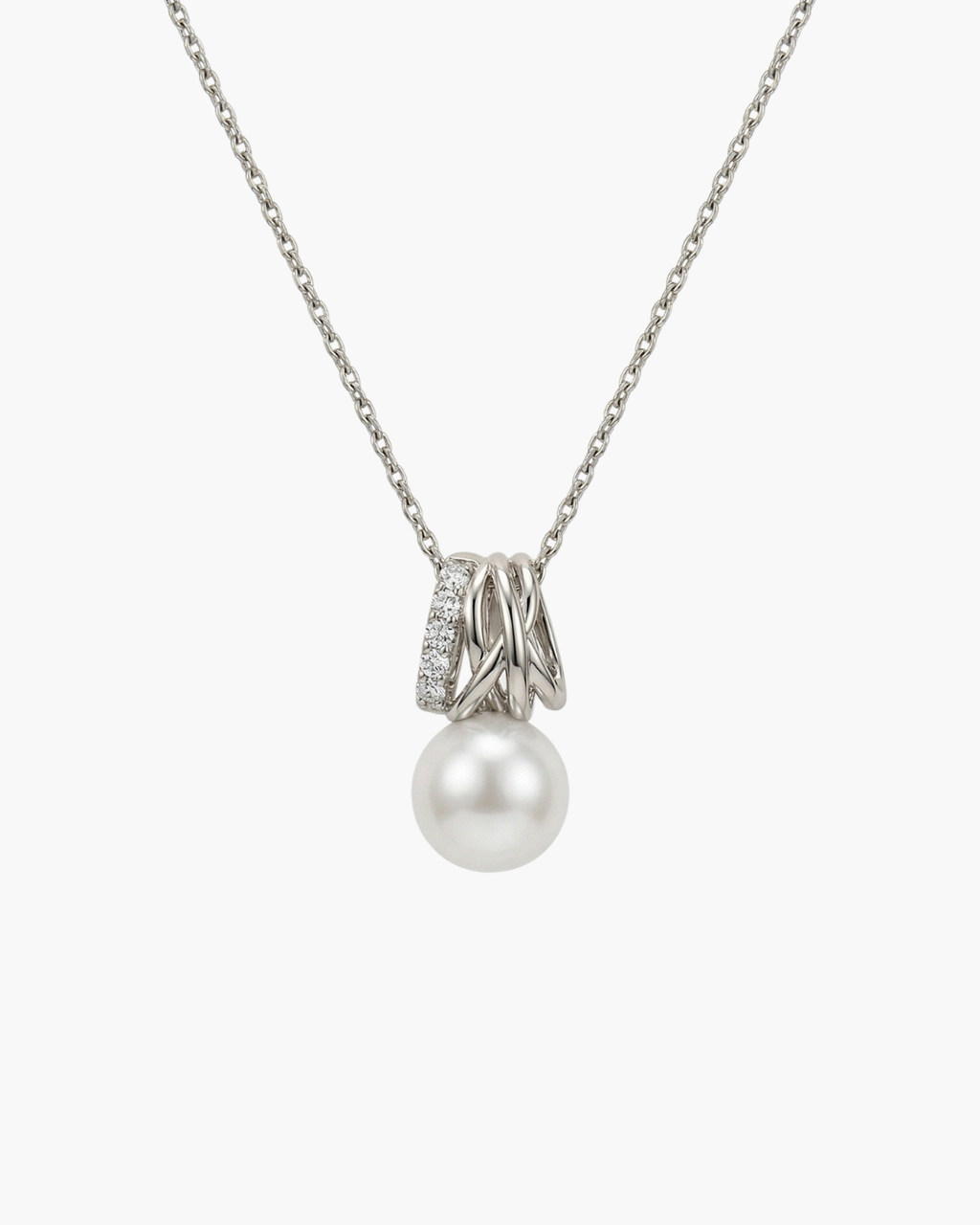 Macro view of a gold-plated entwined orbit pendant necklace with micro-paved zircons and a large white natural pearl hanging below.