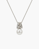 Macro view of a gold-plated entwined orbit pendant necklace with micro-paved zircons and a large white natural pearl hanging below.