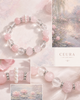 Top view of a pastel pink and clear crystal gemstone bracelet featuring large round beads, a carved pink quartz teddy bear, and tiny white pearls.